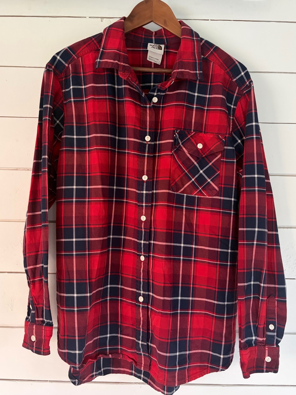 The North Face red plaid flannel button down shirt. Size: Large